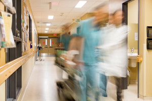 Blurred motion of doctor and nurse pulling stretcher in hospital